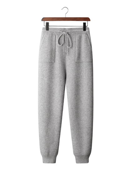 Gray sweatpants on a hanger against a white background
