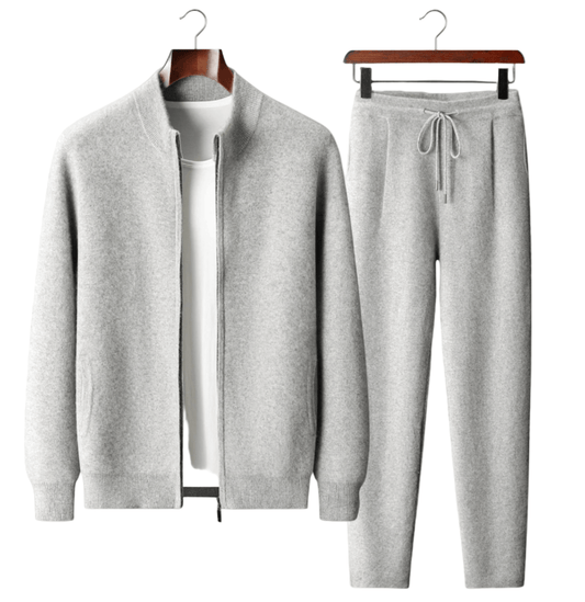 Gray tracksuit on hangers against a white background