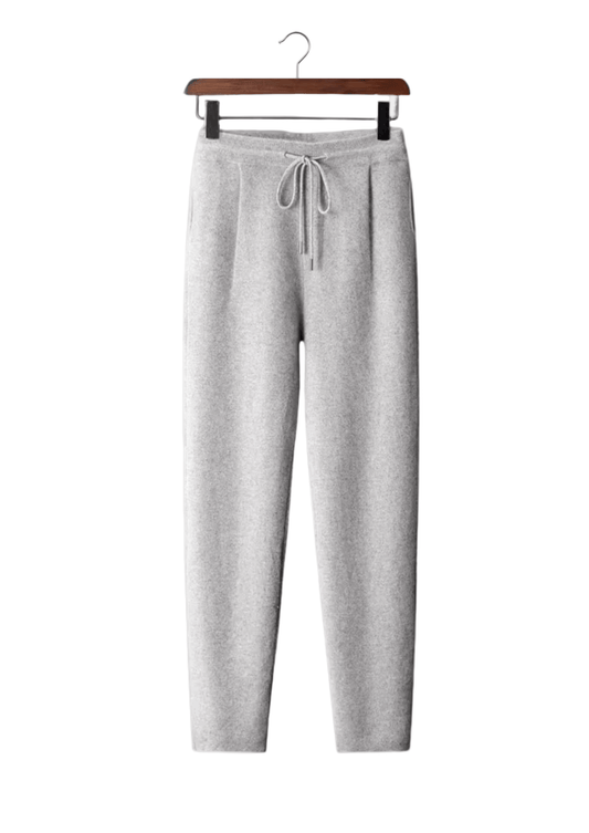 Gray sweatpants on a hanger against a white background