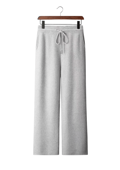 Gray sweatpants on a hanger against a white background