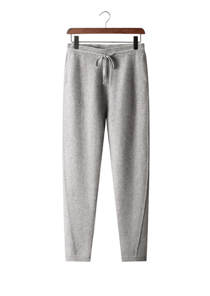 Gray sweatpants on a hanger against a white background