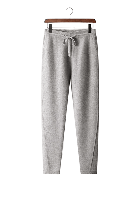 Gray sweatpants on a hanger against a white background