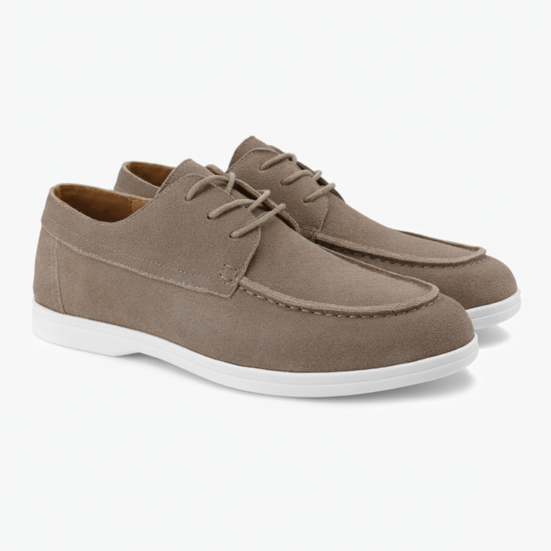 Pair of brown suede shoes with white soles on a white background