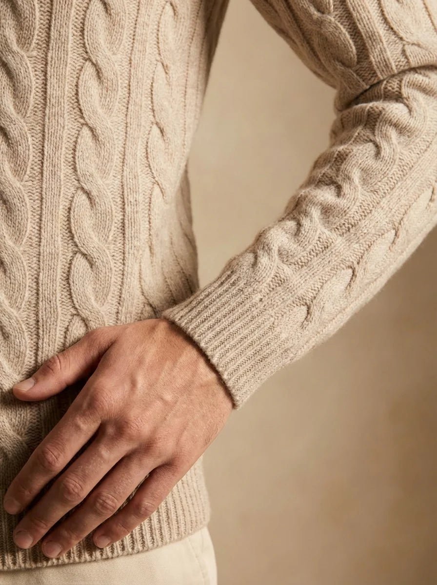 Man wearing a beige 100% cashmere sweater with a refined ribbed crewneck and cuffs.