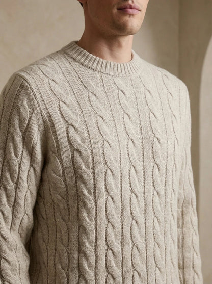 Man wearing a beige 100% cashmere sweater with a refined ribbed crewneck and cuffs.