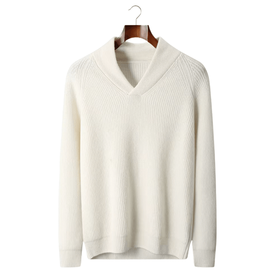 White sweater on a wooden hanger against a white background