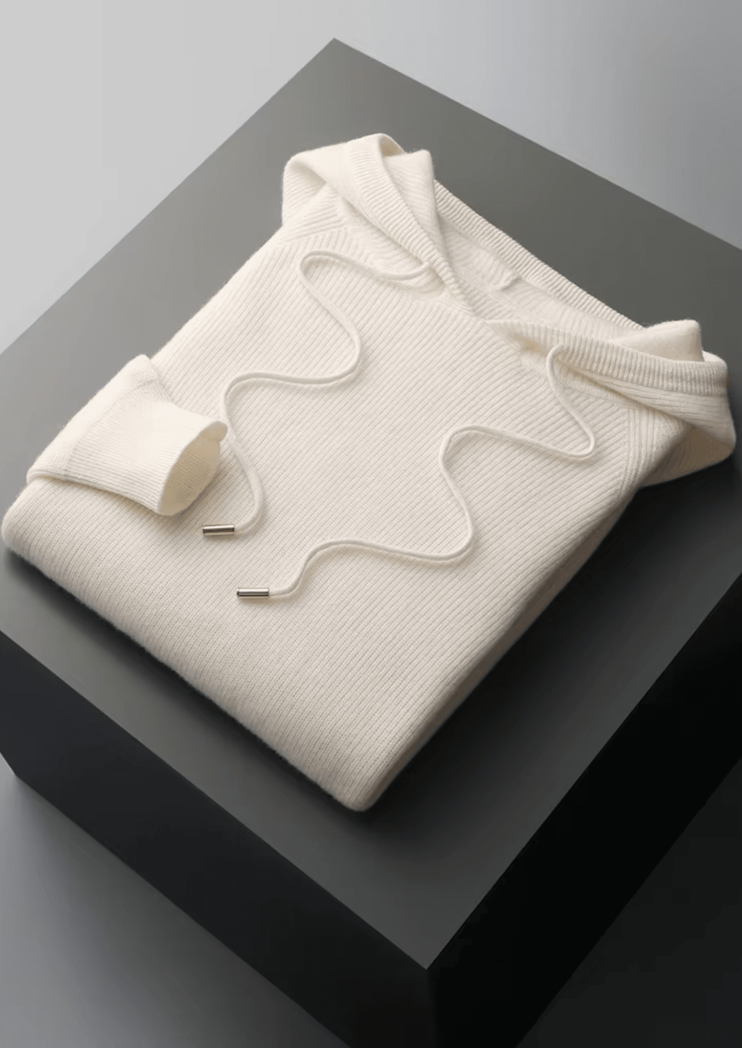 Elegant ivory white Merino wool tracksuit featuring a soft-touch knit hoodie and matching tailored joggers with tonal stripes.