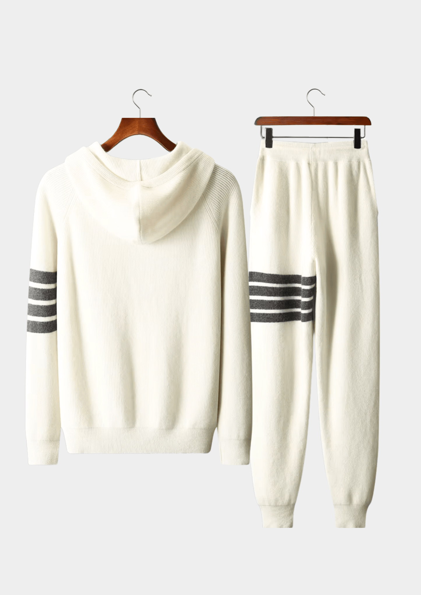 Elegant ivory white Merino wool tracksuit featuring a soft-touch knit hoodie and matching tailored joggers with tonal stripes.