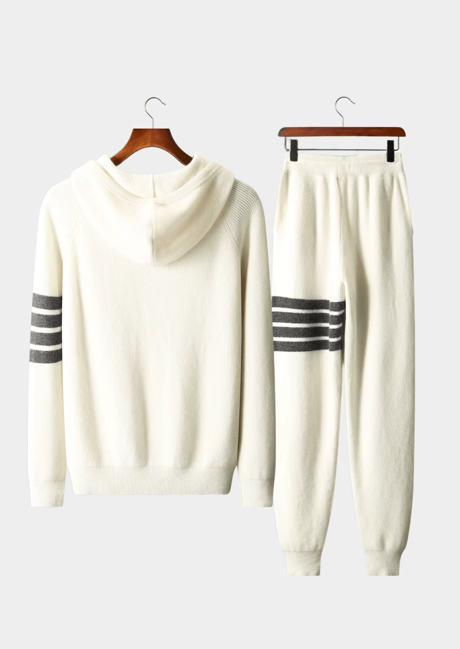 Elegant ivory white Merino wool tracksuit featuring a soft-touch knit hoodie and matching tailored joggers with tonal stripes.