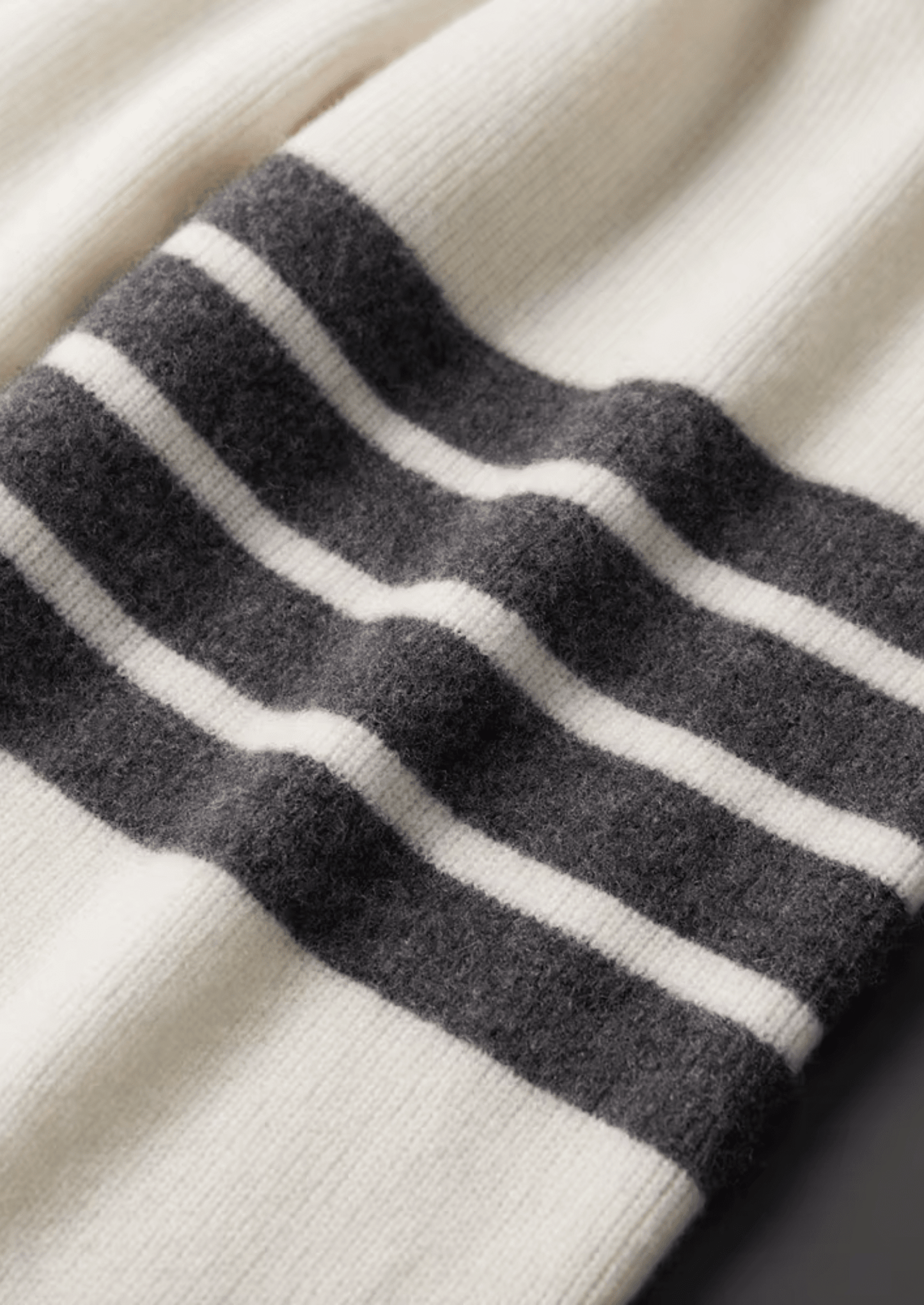 Elegant ivory white Merino wool tracksuit featuring a soft-touch knit hoodie and matching tailored joggers with tonal stripes.