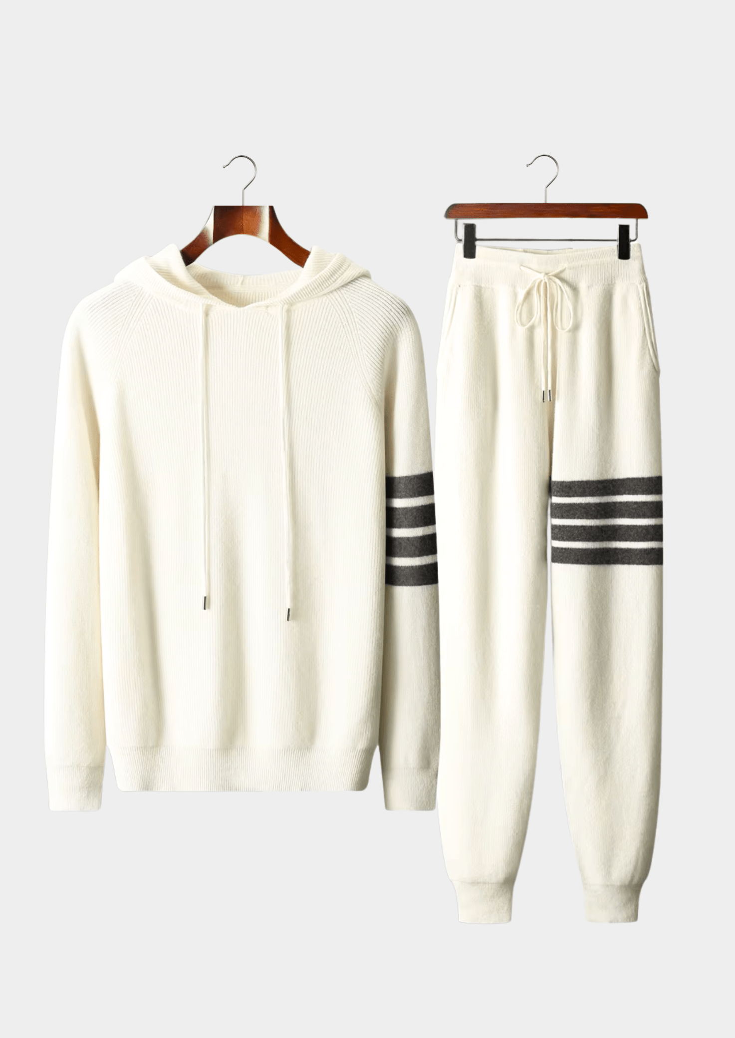 Elegant ivory white Merino wool tracksuit featuring a soft-touch knit hoodie and matching tailored joggers with tonal stripes.
