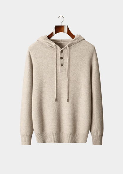 Beige hoodie on a wooden hanger against a light gray background