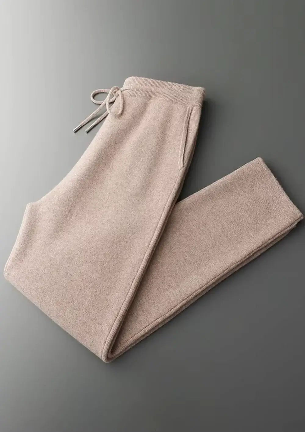 Beige sweatpants on a gray background