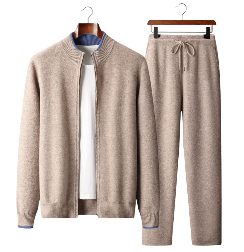 Beige sweater and pants set on hangers against a white background