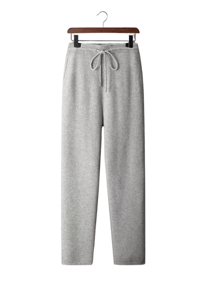 Gray sweatpants on a hanger against a white background