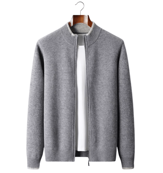Gray zip-up sweater on a hanger against a light gray background