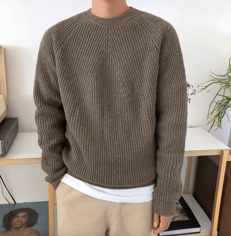 Men's brown relaxed-fit ribbed sweater featuring raglan sleeves and a 100% cotton knit construction.