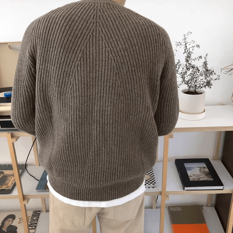 Men's brown relaxed-fit ribbed sweater featuring raglan sleeves and a 100% cotton knit construction.