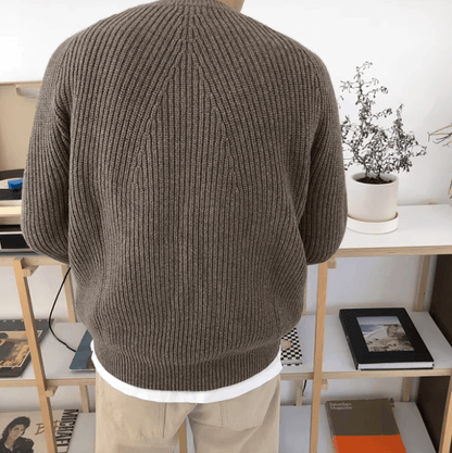 Men's brown relaxed-fit ribbed sweater featuring raglan sleeves and a 100% cotton knit construction.
