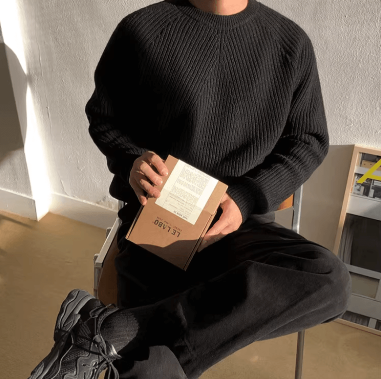 Classic black raglan sleeve crew neck for men with a technical vertical ribbed texture and loose fit.