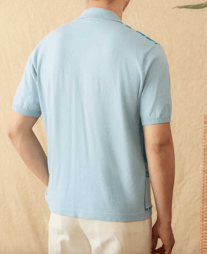 Men's light blue button-through knitted polo featuring a front pocket and white striped trim on the collar and cuffs.