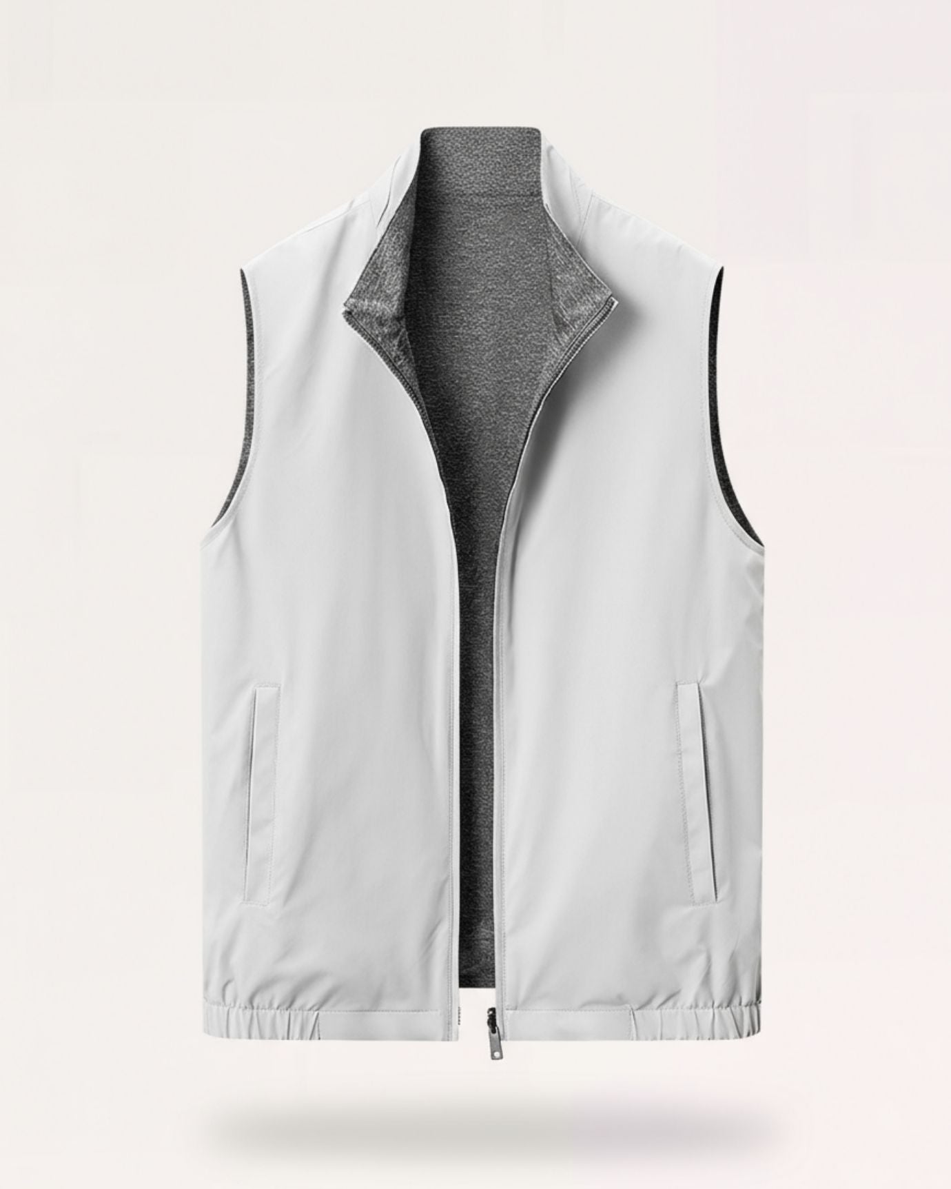 Men's minimalist reversible vest in gray-white, featuring a technical outer face and a soft-textured inner lining.