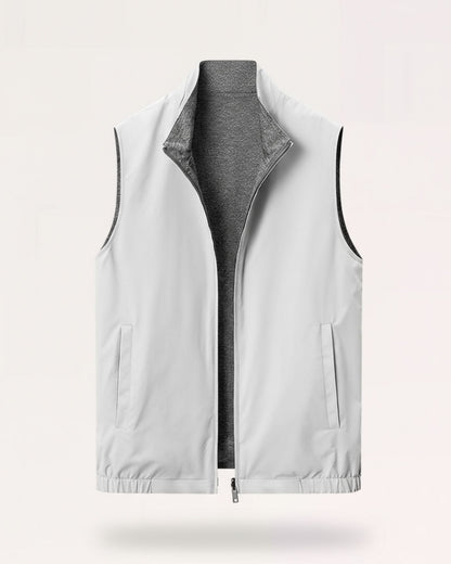 Men's minimalist reversible vest in gray-white, featuring a technical outer face and a soft-textured inner lining.