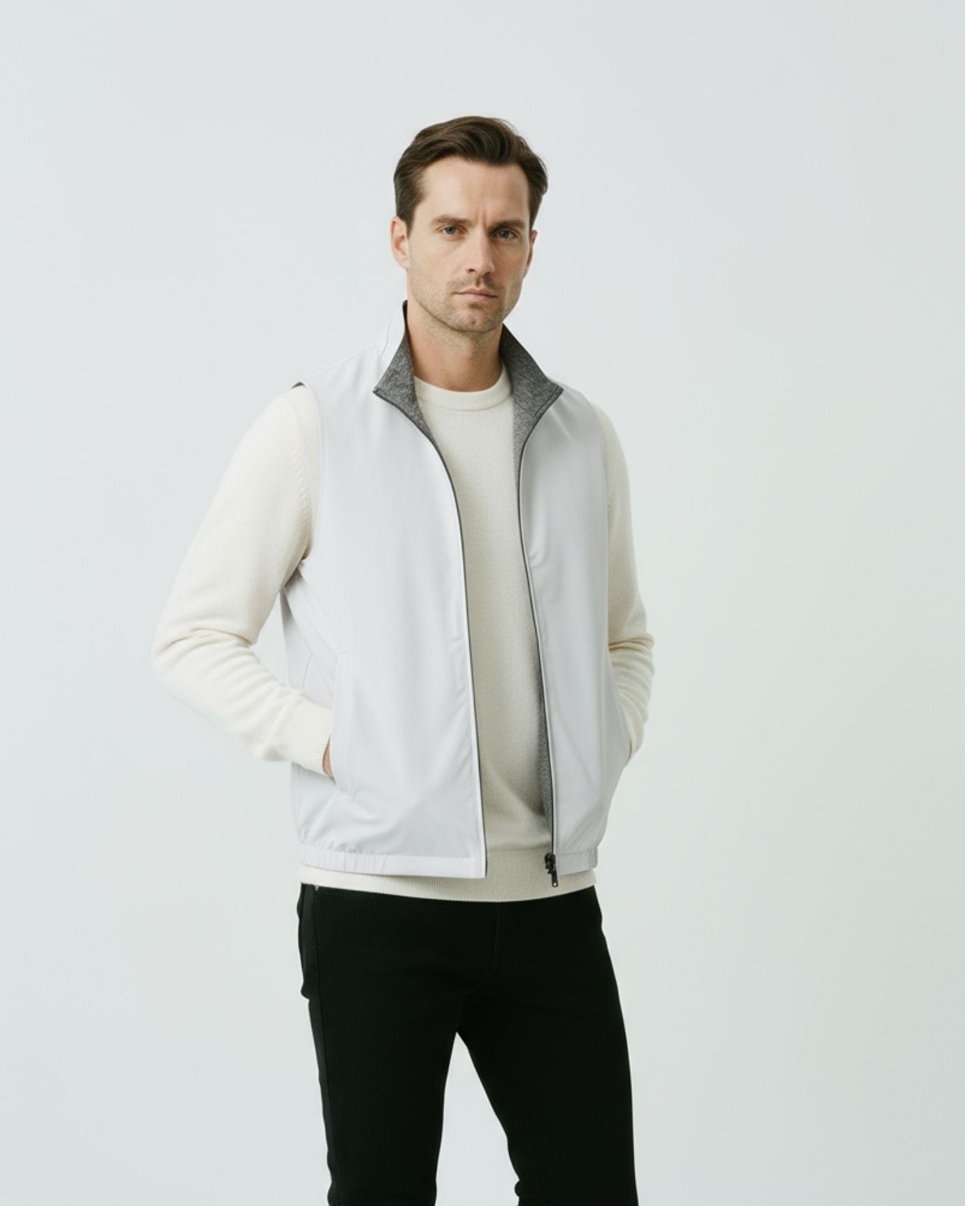 Men's minimalist reversible vest in gray-white, featuring a technical outer face and a soft-textured inner lining.