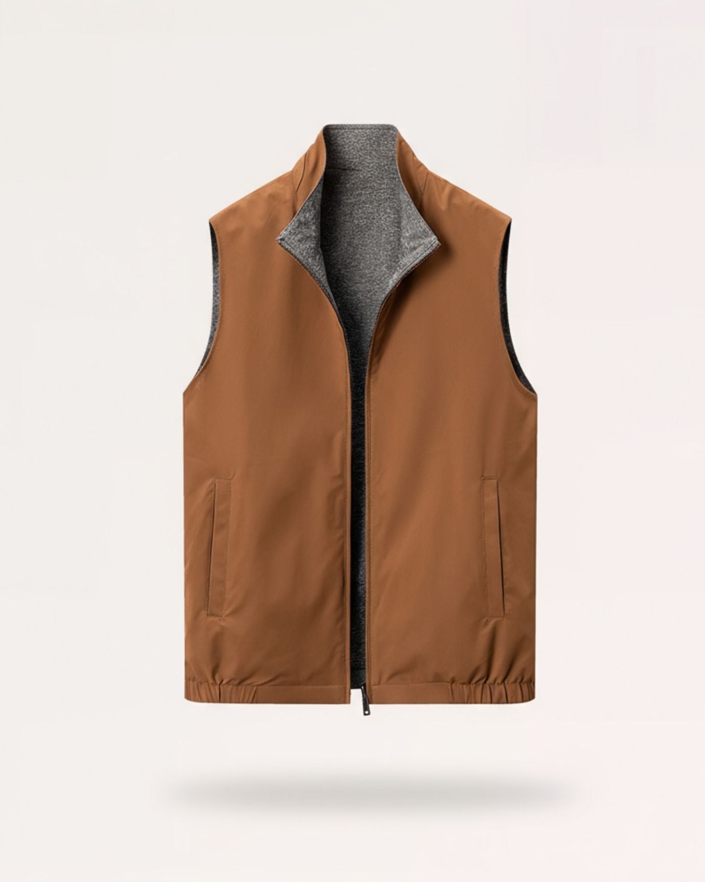 Men's reversible dual-face vest in earth-tone brown with a contrasting heathered gray interior and metal hardware.