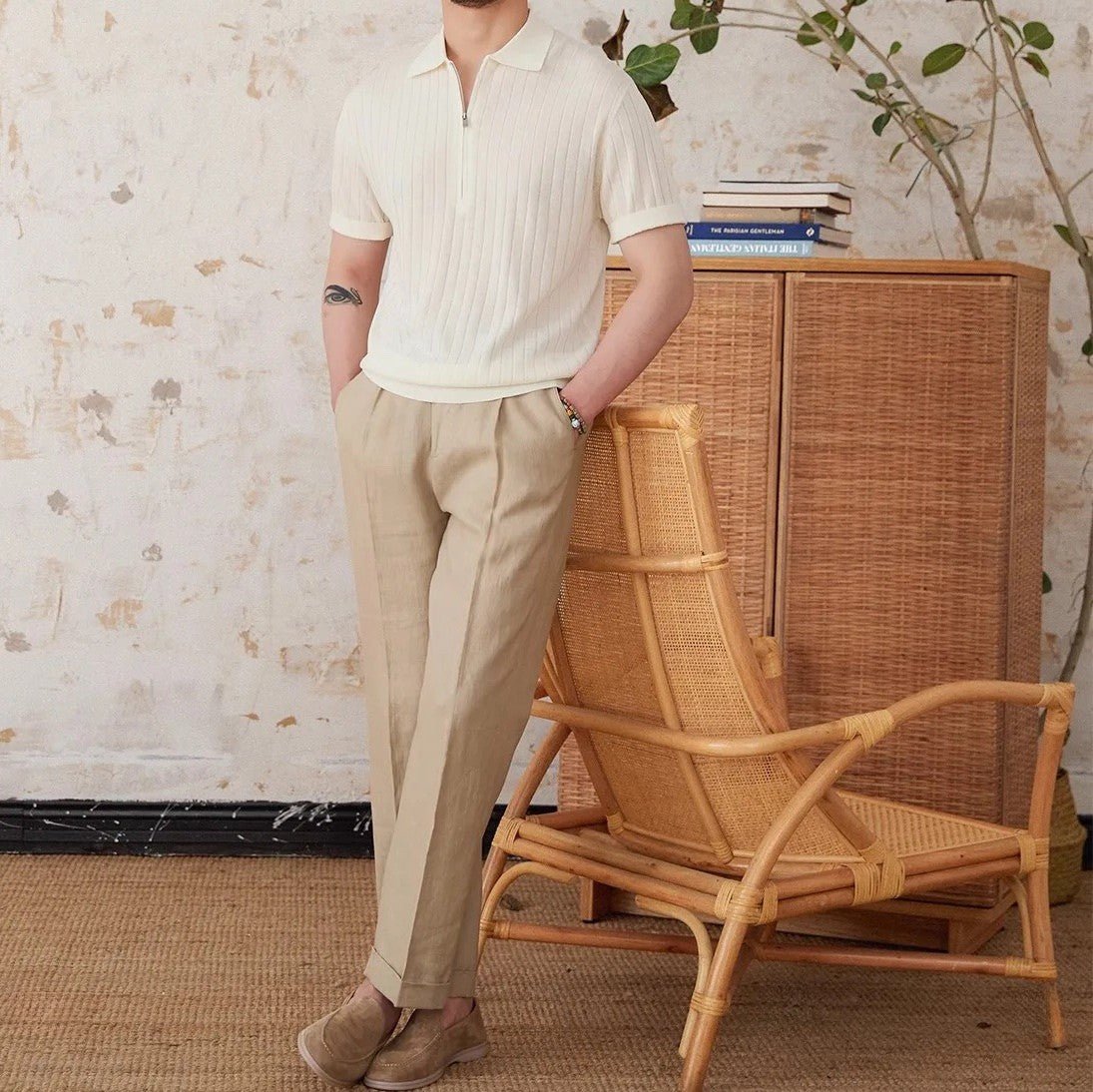 Men's crisp white ribbed half-zip polo crafted from a breathable linen blend with a modern metallic zipper detail.