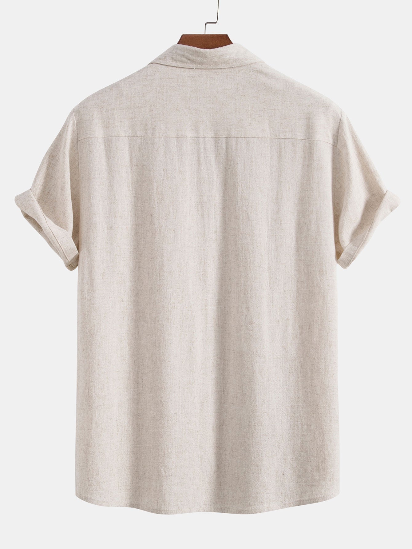 Beige short-sleeve shirt on a hanger against a white background