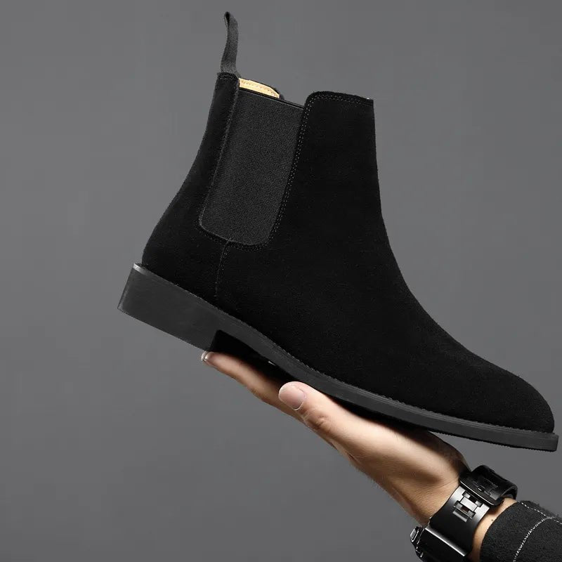 Sophisticated black suede Chelsea boots with a streamlined pointed toe, perfect for a coordinated Old Money aesthetic.