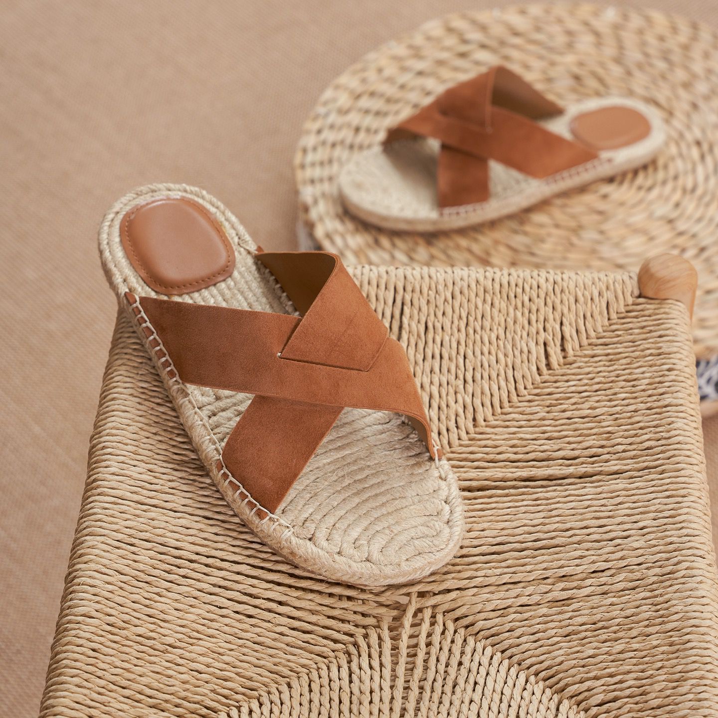 Vibrant orange suede open-toe sandals featuring a lightweight construction and braided jute trim.