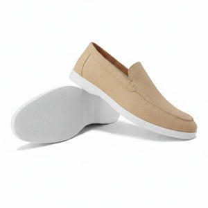 Men's tan suede loafers with tonal stitching and a flexible, low-profile cream sole for a relaxed resort look.