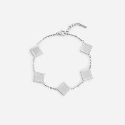 Silver bracelet with square pendants on a white background