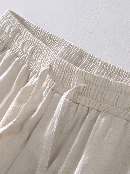 Close-up of beige pants with an elastic waistband on a light gray background