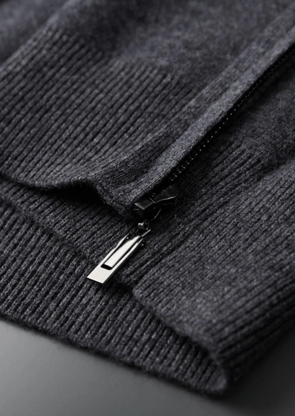 Close-up of a dark gray sweater with a zipper on a dark background