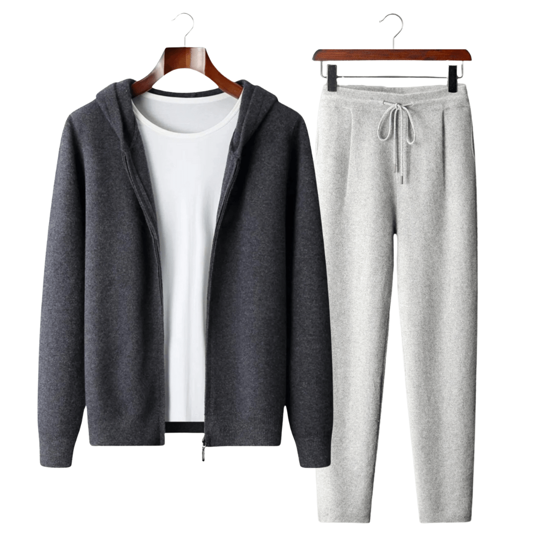 Gray hoodie and pants set on hangers against a white background