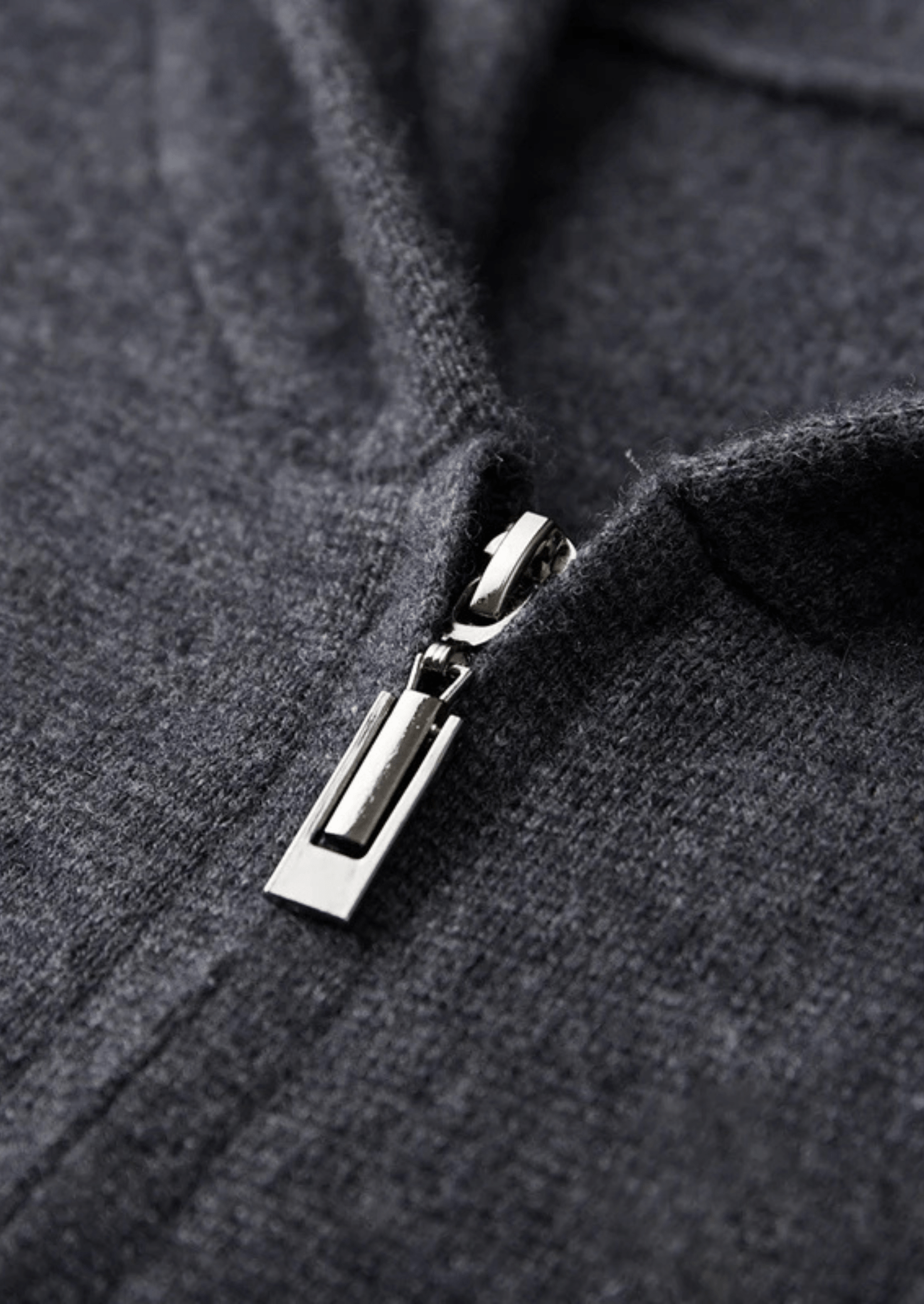 Close-up of a zipper on a dark gray fabric