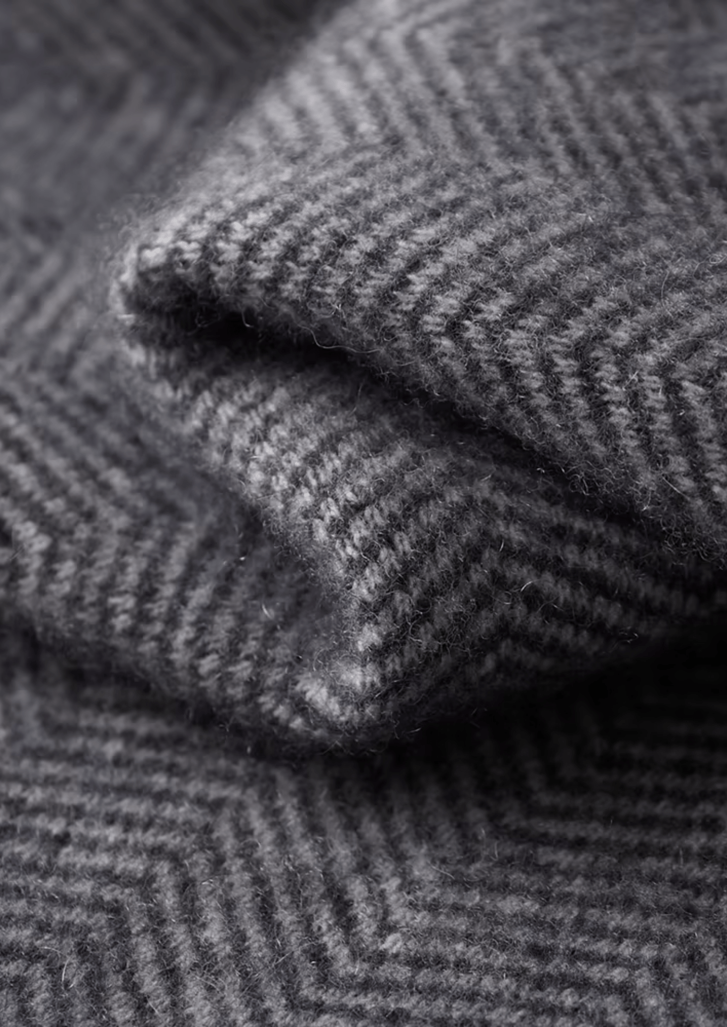 Close-up of folded gray herringbone fabric