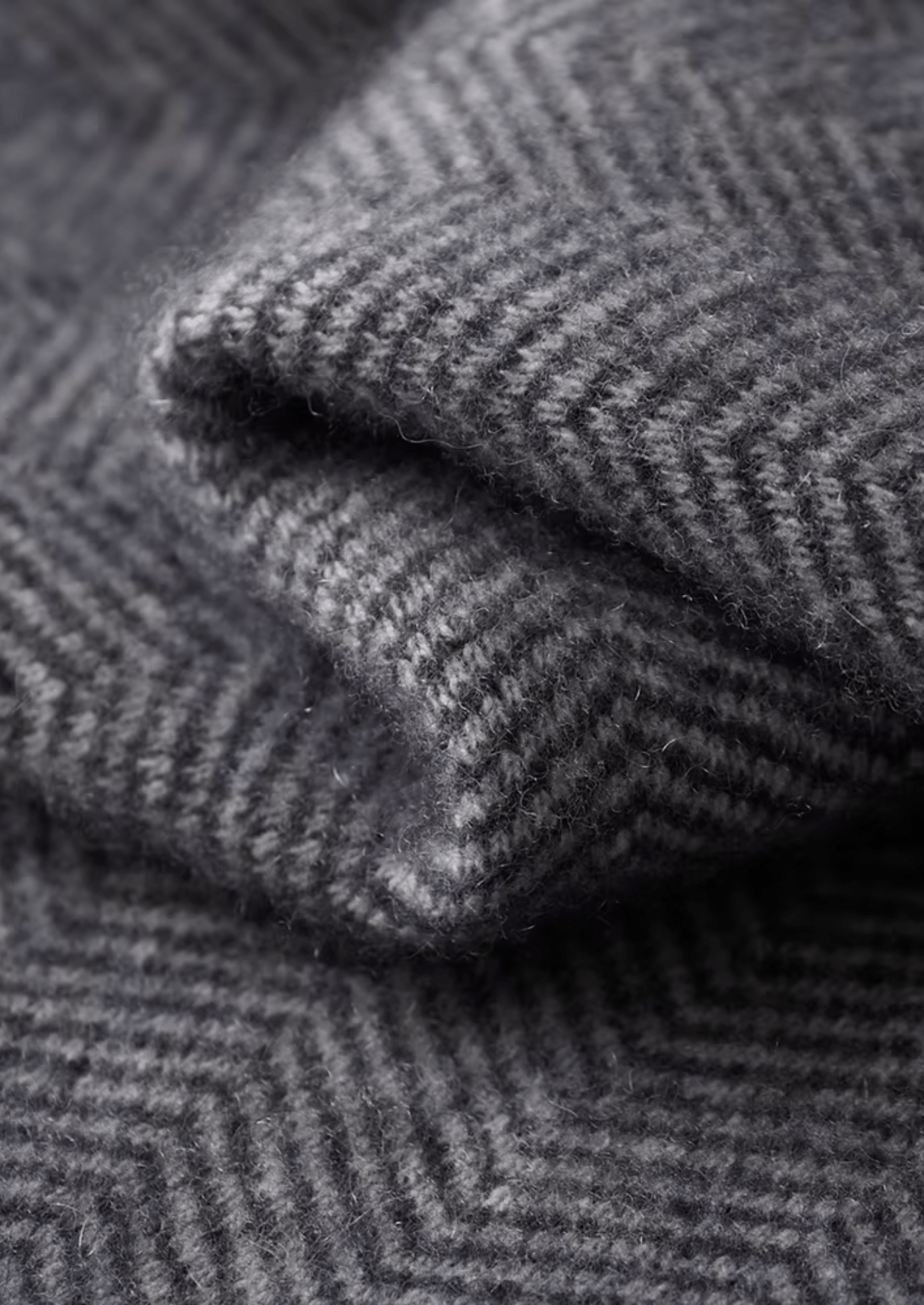 Close-up of folded gray herringbone fabric