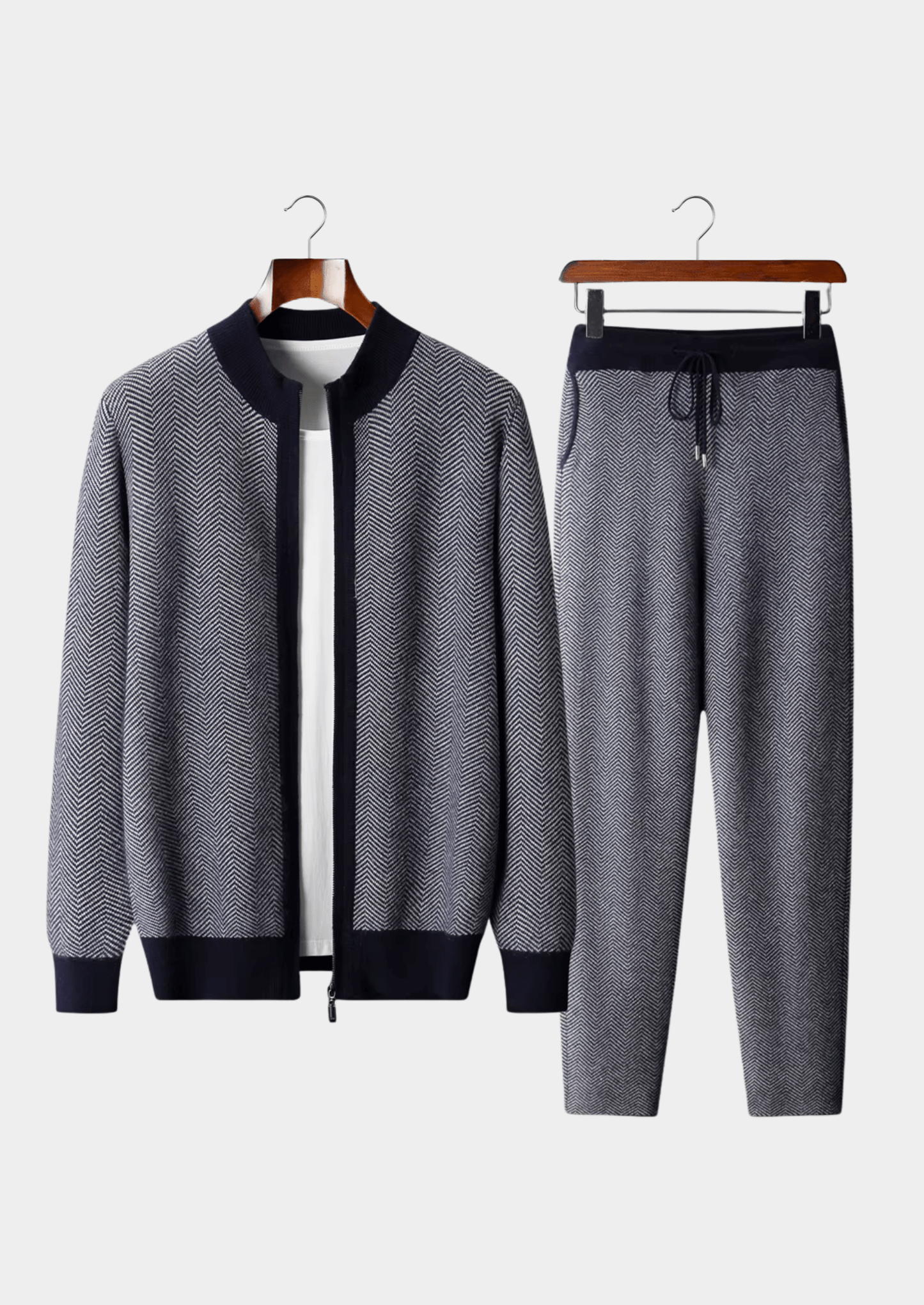 Gray tracksuit with black accents on hangers against a white background
