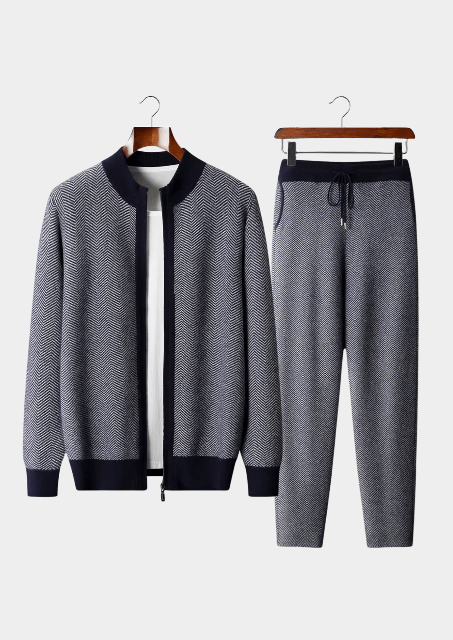 Gray tracksuit with black accents on hangers against a white background