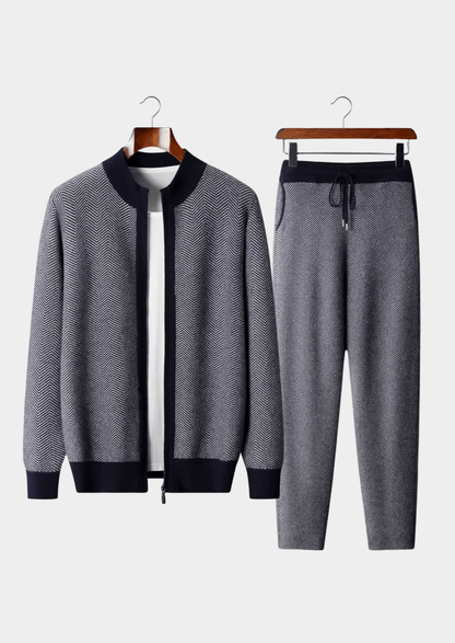 Gray tracksuit with black accents on hangers against a white background