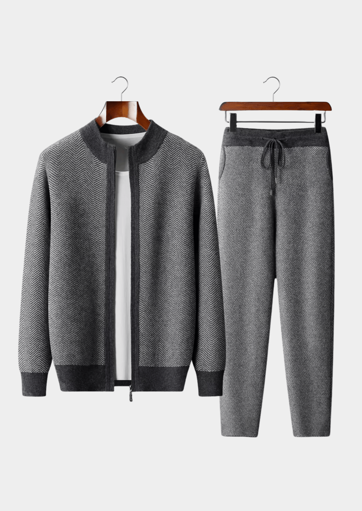 Gray tracksuit with jacket and pants on hangers against a white background
