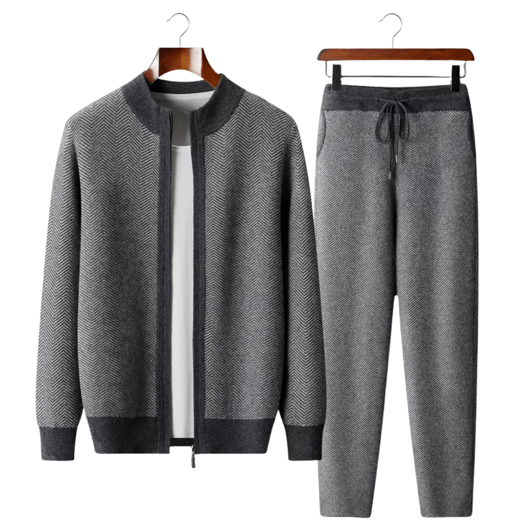 Gray herringbone jacket and pants set on hangers against a white background