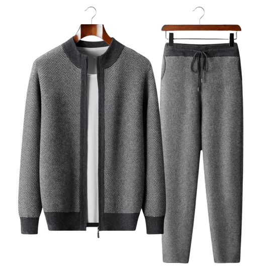 Gray herringbone jacket and pants set on hangers against a white background