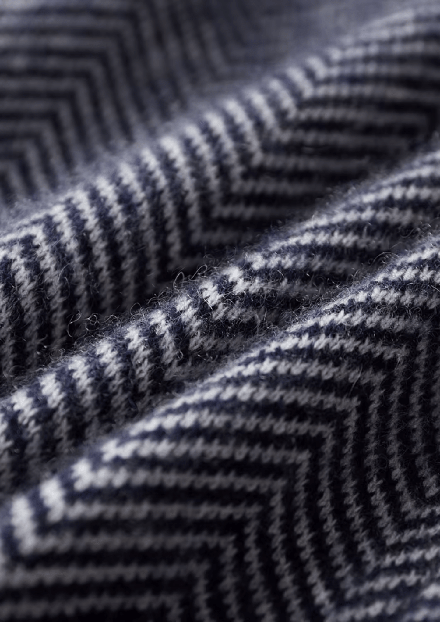 Close-up of a textured fabric with a zigzag pattern in black and gray.