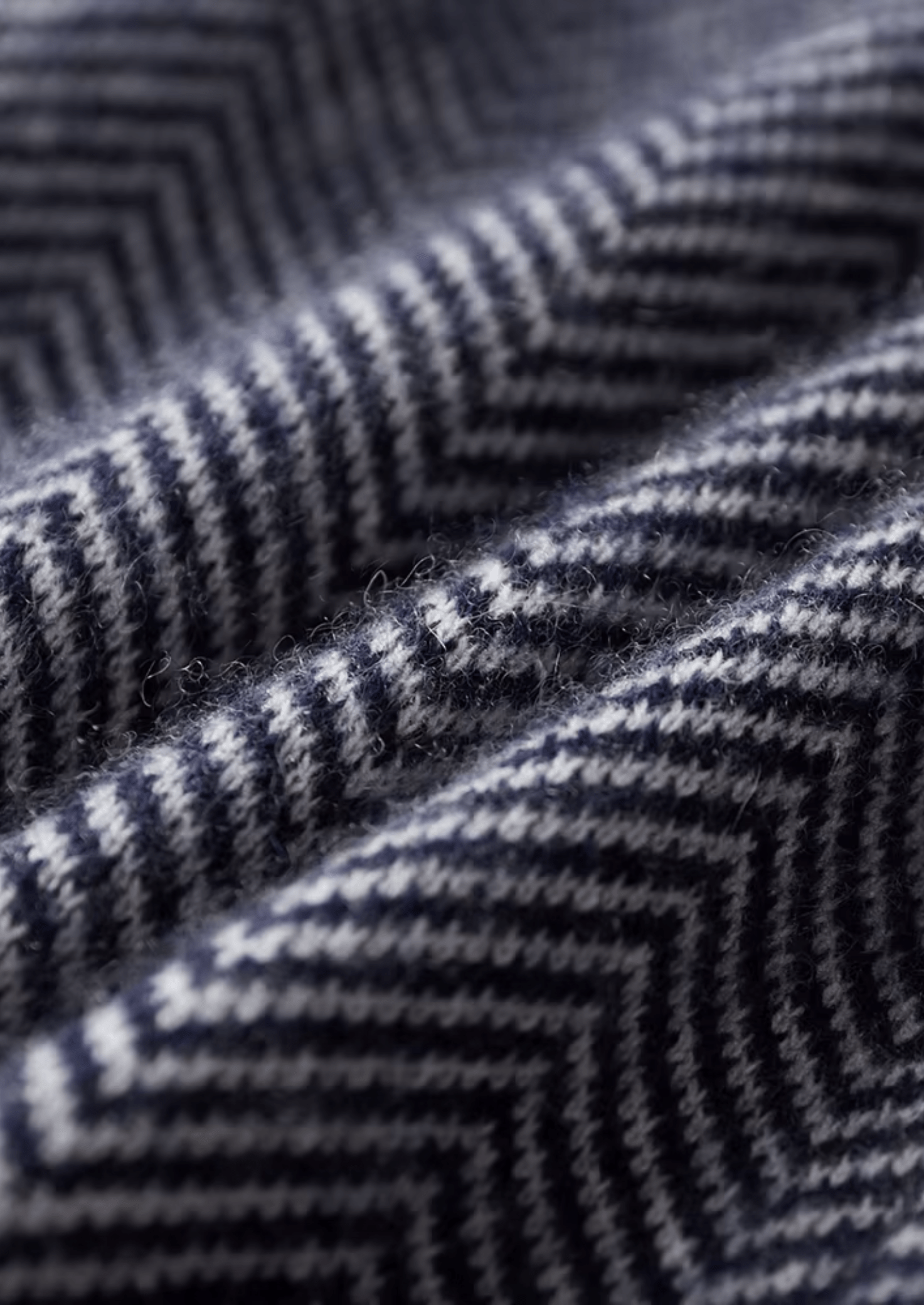 Close-up of a textured fabric with a zigzag pattern in black and gray.