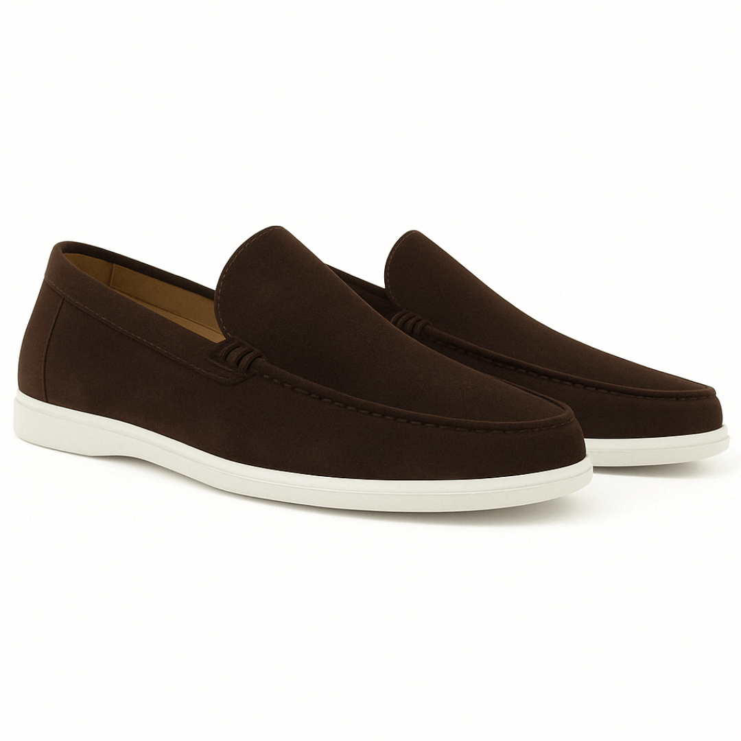 Pair of brown loafers with white soles on a white background
